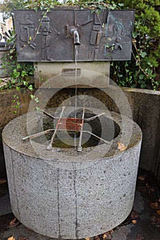 Public free clean drinking water from antique faucet in Kitzbuhel, Austria, Europe