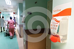 Public hand disinfectant sanitizer dispenser available in hospital for hygiene photo
