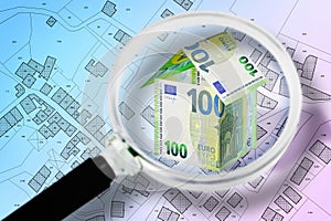 Public housing and real estate concept seen through a magnifying glass with house of european euro banknotes agains an imaginary