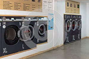 Public laundry place, industrial washing machines in laundrette