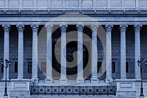 A public law court in Lyon, France, with a neoclassical colonnade corinthian style columns - in blue color tone