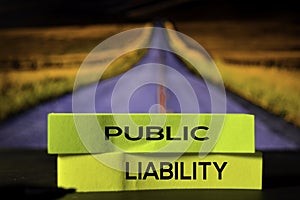 Public Liability on the sticky notes with bokeh background