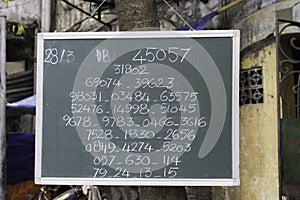 Public lottery result wrote on a board in Hanoi