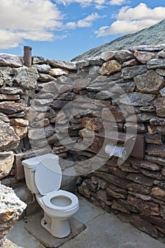 Public outdside stone restroom without roof at des