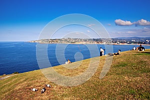 People Sunbathing in front of the sea in Gijon
