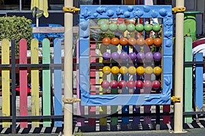 Public playground with abacus for children practicing counting with bright colored wooden beads