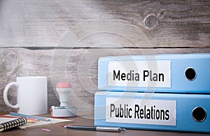 Public Relations and Media Plan. Two binders on desk in the office. Business background