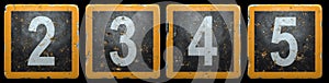 Public road sign orange and black color with a set of numbers 2, 3, 4, 5 in the center isolated on black background. 3d