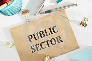 Public Sector text written on a craft envelope with office tools