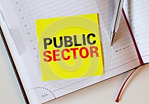 Public Sector text written on a notebook with pencils