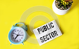 Public sector text written on notepad and yellow background