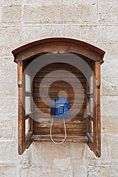 Public semi-open wooden telephone in a street in the old town of Lviv, Ukraine