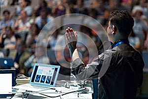 Public speaker giving talk at Business Event.