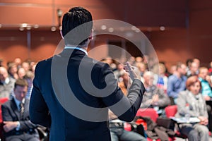 Public speaker giving talk at business event.