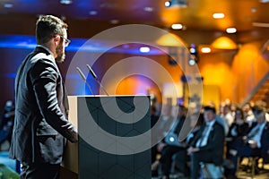 Public speaker giving talk at business event. photo