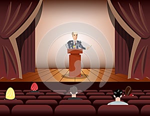 Public speaker speaking to microphones on stage