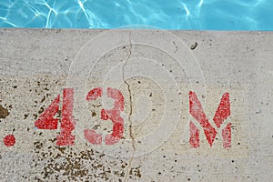 Public swimming pool, at pool`s edge showing lettering