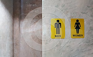 Public toilet of men and women. Sign of lady and gentleman washroom called wc. Mixed gender symbol toilet and restroom behind