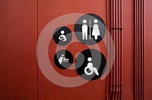 Public toilet sign. Woman, men, children, baby diaper changing, and disabled person toilet icon on restroom wall. Public restroom