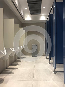 Public toilets with some male urinals and bathroom