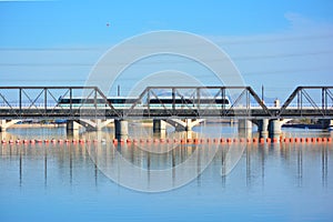 Public Transit Light Rail Train Crossing Bridge over Water