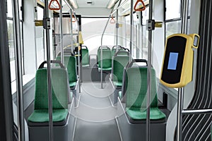 Public transport interior with comfortable green seats and contactless fare payment devices