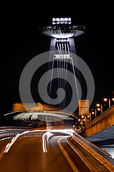 Public transportation bus during night with SNP bridge in the back