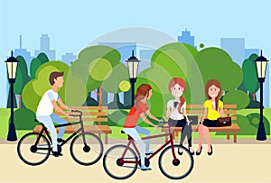 Public urban park woman man sitting wooden bench outdoors walking cycling running green lawn trees on city buildings