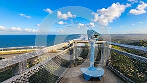 Public viewing binoculars on the headland at Cape Byron, Byron Bay tourist destination in Australia