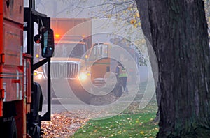 Public works in Mount Prospect IL, USA. Service trucks in a fog.