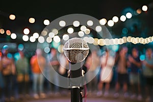 Publish Microphone on stage at outdoor night party, bokeh background photo