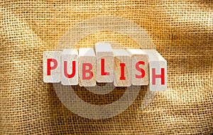 Publish symbol. The concept word Publish on wooden blocks. Beautiful canvas background, copy space. Business publish and