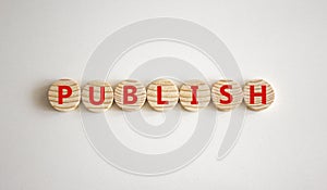 Publish symbol. The concept word Publish on wooden circles. Beautiful white background, copy space. Business publish and