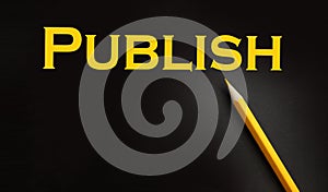 Publish word printed in yellow on black paper. Publishing business concept