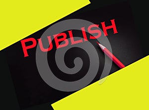 Publish word printed in yellow on black paper. Publishing business concept