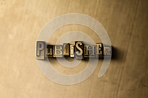 PUBLISHER - close-up of grungy vintage typeset word on metal backdrop