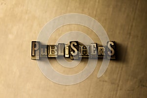 PUBLISHERS - close-up of grungy vintage typeset word on metal backdrop photo