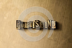 PUBLISHING - close-up of grungy vintage typeset word on metal backdrop photo