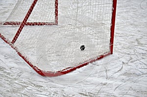 puck and goal on ice, playing hockey