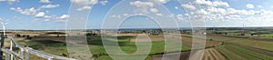 Pucka Bay panorama captured from wind mill nacelle - blue sky, clouds, sky climber hanging platform and wind park photo