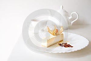 Pudding cake on white plate with tea cups