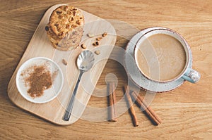 Pudding with cinnamon, stacked chip cookies and a cup of coffee