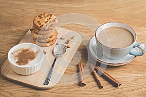 pudding with cinnamon, stacked chip cookies and a cup of coffee/pudding with cinnamon, stacked chip cookies and a cup of coffee on