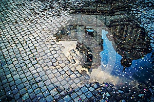 A puddle reflection of the basilica of St Agnes on Piaza Navona, Rome, Italy