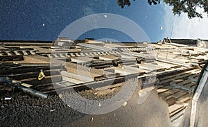 A puddle on the street and a reflection of a multi-storey residential building