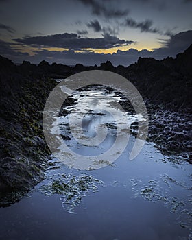 Twilight on rocky beach in Freshwater West, Pembrokeshire, South Wales,UK