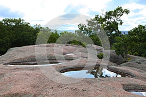 Puddles on top of giant granite boulders in Elephant Rock State Park, Belleview, Missouri