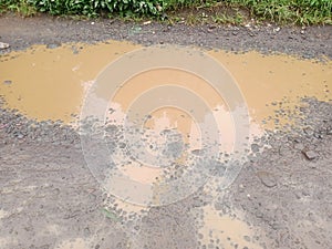 puddles of water on potholed roads to indo