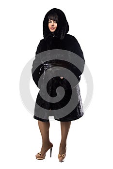 Pudgy brunette in black coat with hood