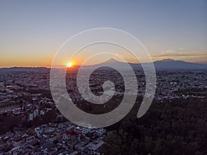 Puebla at Dramatic evening Sunset aerial drone shot of City Center in Puebla de Zaragoza, Puebla State, Mexico photo